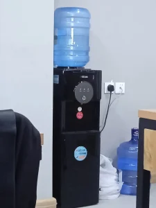 A water cooler in an office, where workplace drinking habits meet questions about plastic.