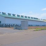 Rows of container-sized battery units at a grid storage facility
