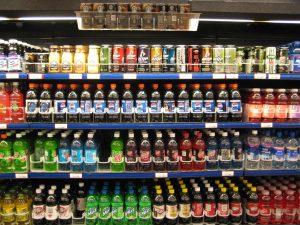 Person comparing nutrition information on packaged food in a store